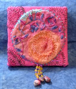 hand embroidered tango tangerine moon textile art